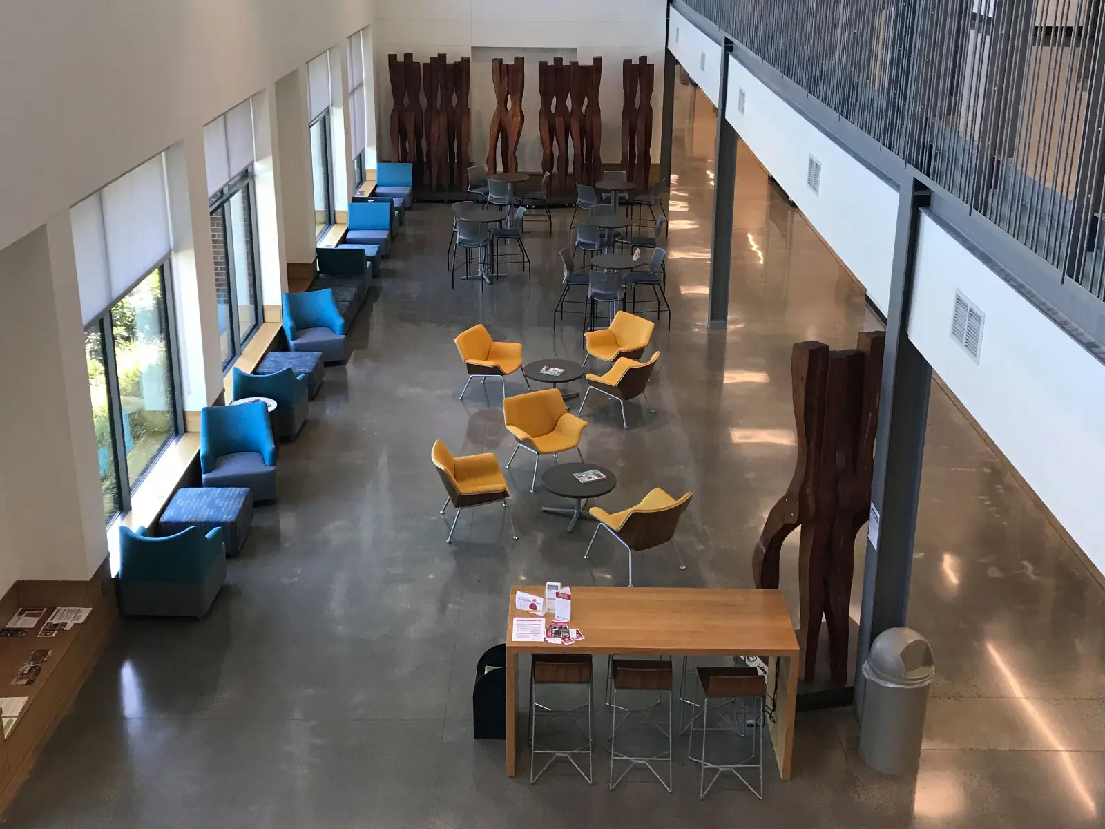 The vast, open-spaced and chair-filled Harmony lobby, with two floors and artwork