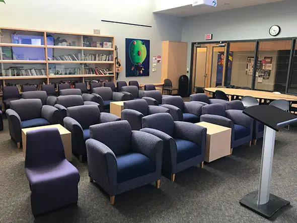 Rows of comfortable chairs in front of a podium in the Literary Arts Center in Roger Rook at the Oregon City campus